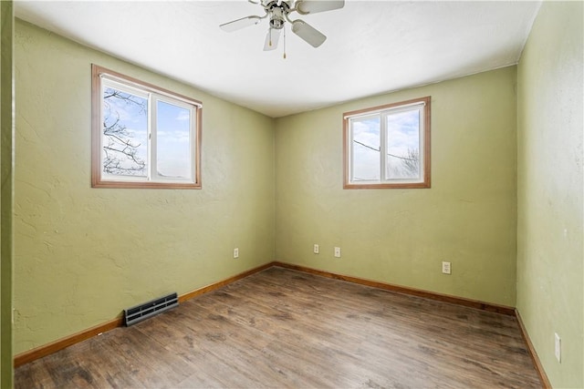 unfurnished room with ceiling fan and hardwood / wood-style floors