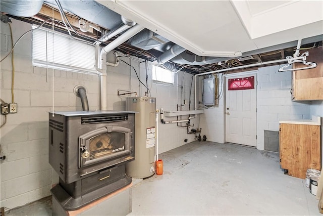 basement featuring electric panel and water heater