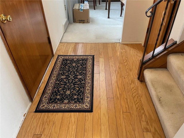 hallway with light hardwood / wood-style floors