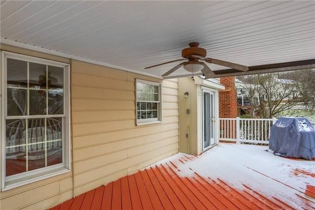 snow covered deck with area for grilling and ceiling fan