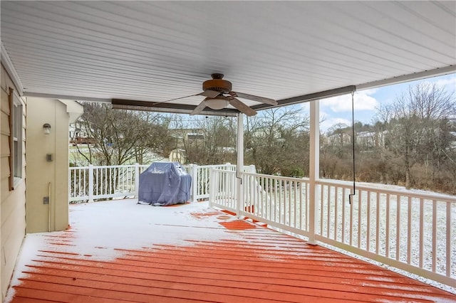 snow covered deck featuring ceiling fan and area for grilling