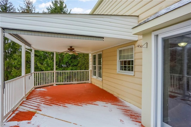 wooden deck featuring covered porch and ceiling fan