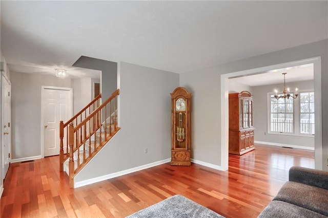 living room featuring hardwood / wood-style floors and an inviting chandelier