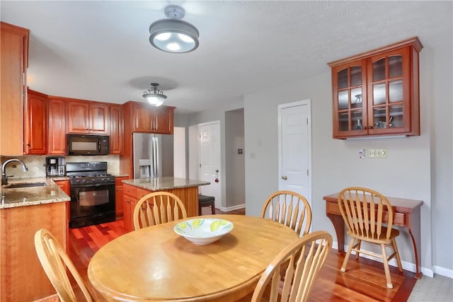 dining room featuring sink and wood-type flooring