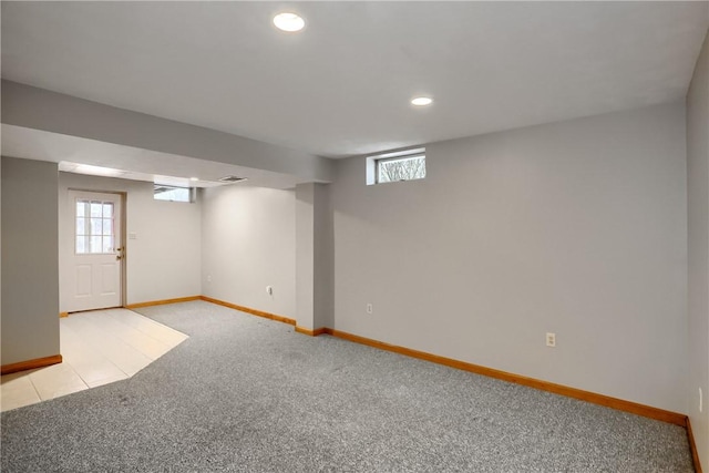 basement with light colored carpet and a wealth of natural light