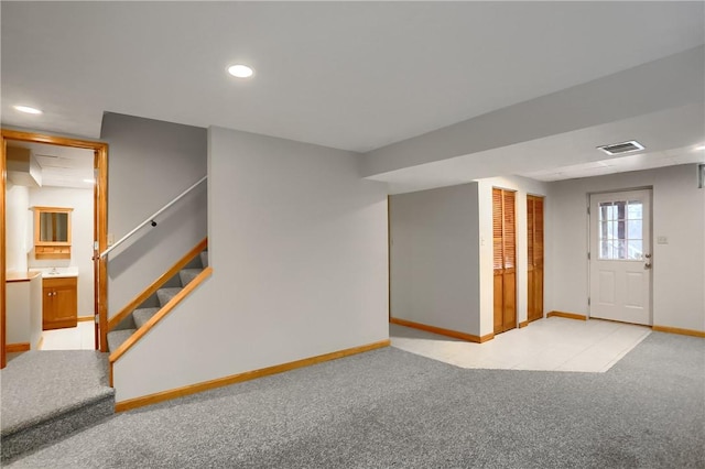 basement featuring light colored carpet