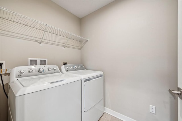 clothes washing area with washer and dryer