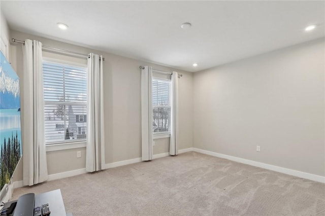 unfurnished room featuring light carpet