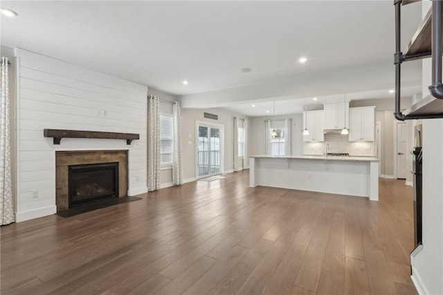 unfurnished living room with dark hardwood / wood-style floors