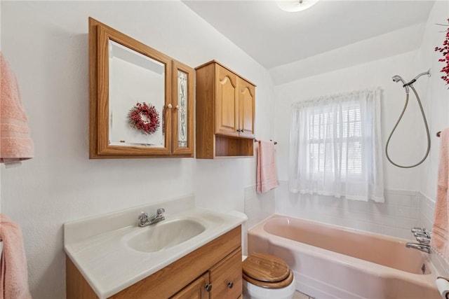 bathroom featuring a tub to relax in, vanity, and toilet