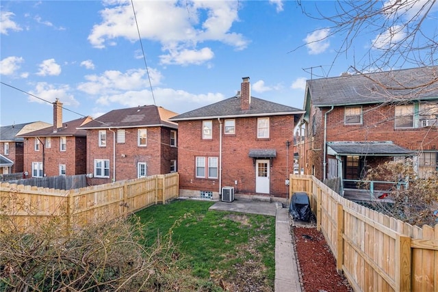 back of property featuring a yard, a patio, and central air condition unit