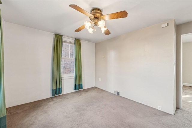 spare room with light carpet and ceiling fan