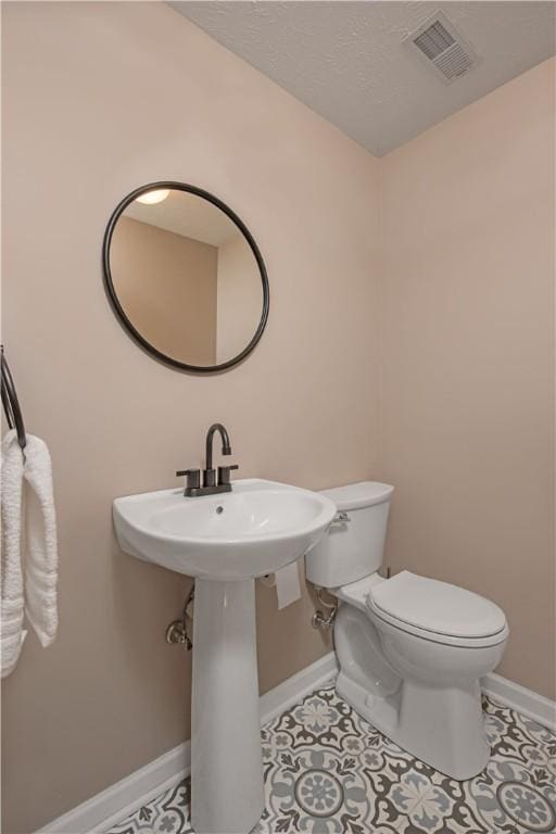 bathroom featuring toilet and tile patterned floors