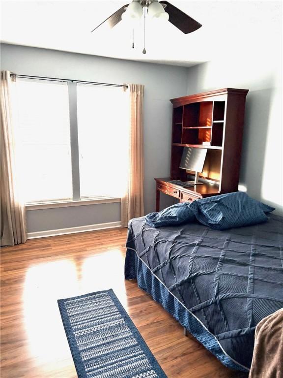 bedroom featuring wood-type flooring and ceiling fan