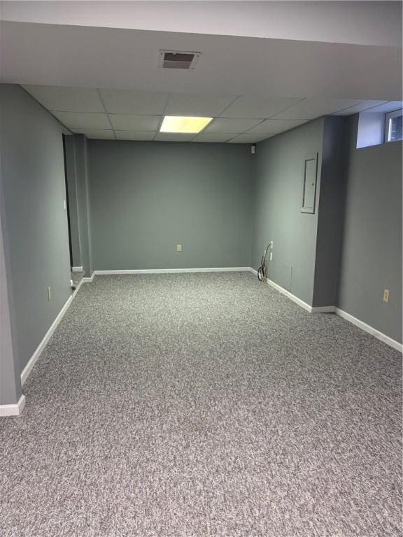 basement featuring carpet floors and a drop ceiling