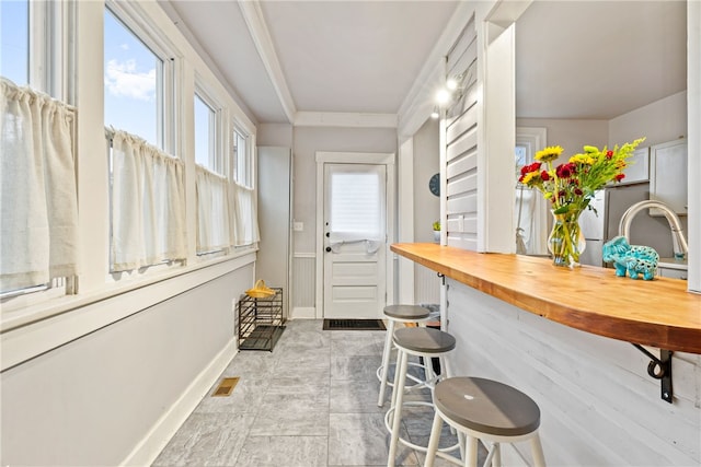 interior space featuring crown molding and sink