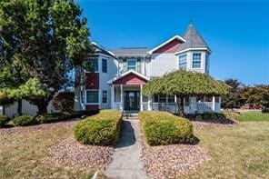 victorian-style house with a front yard