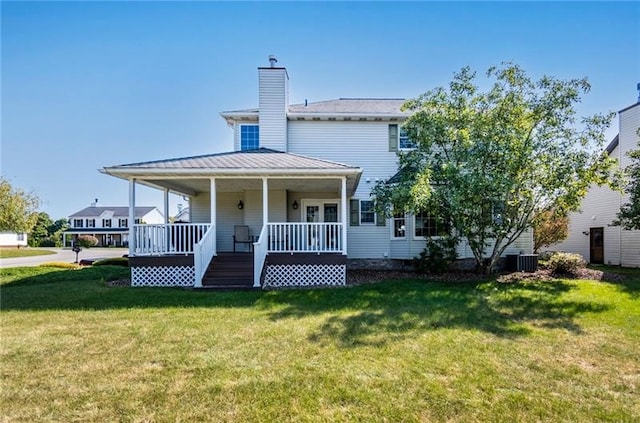 view of front of house featuring cooling unit, covered porch, and a front yard