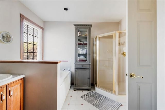 bathroom featuring shower with separate bathtub and vanity