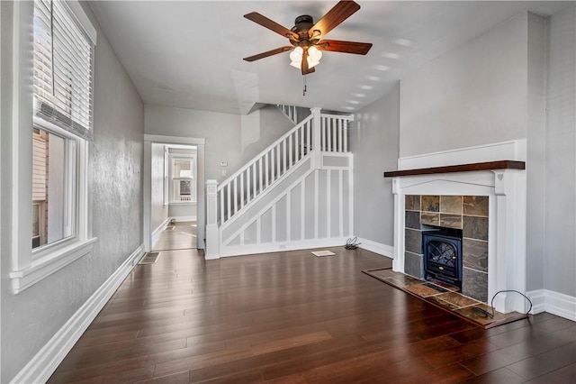 unfurnished living room featuring dark hardwood / wood-style floors and ceiling fan