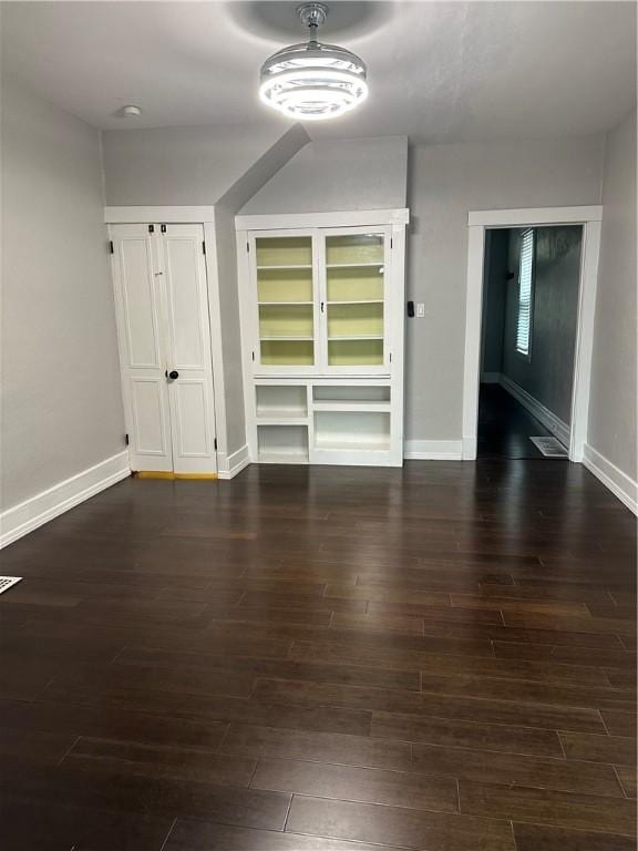 interior space with dark hardwood / wood-style floors and built in features