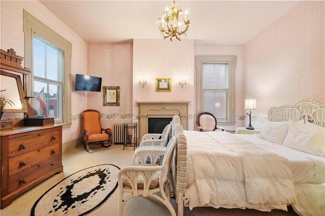 bedroom featuring radiator and a chandelier