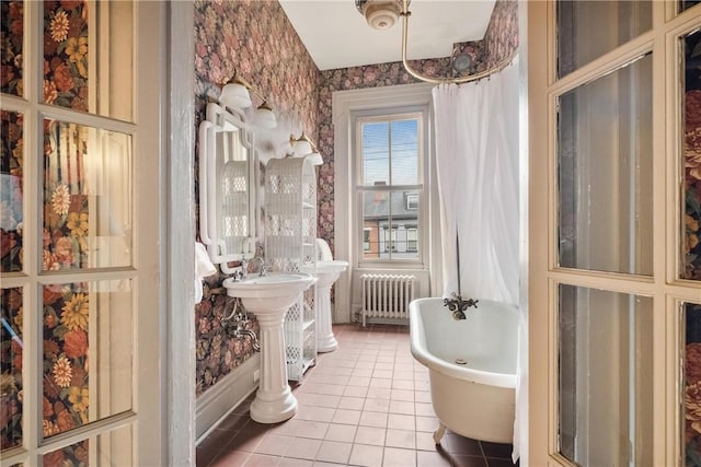 bathroom with tile patterned flooring, plus walk in shower, and radiator