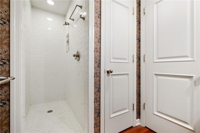 bathroom featuring tiled shower and hardwood / wood-style floors