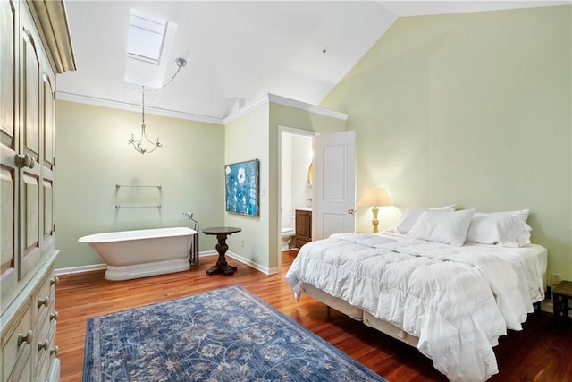 bedroom with wood-type flooring, lofted ceiling with skylight, and crown molding