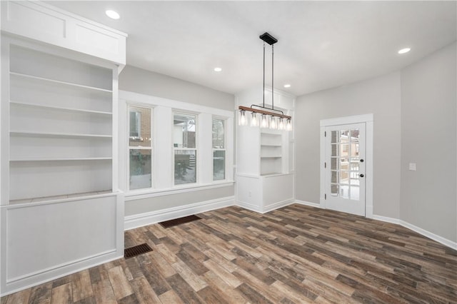 unfurnished dining area featuring dark hardwood / wood-style floors