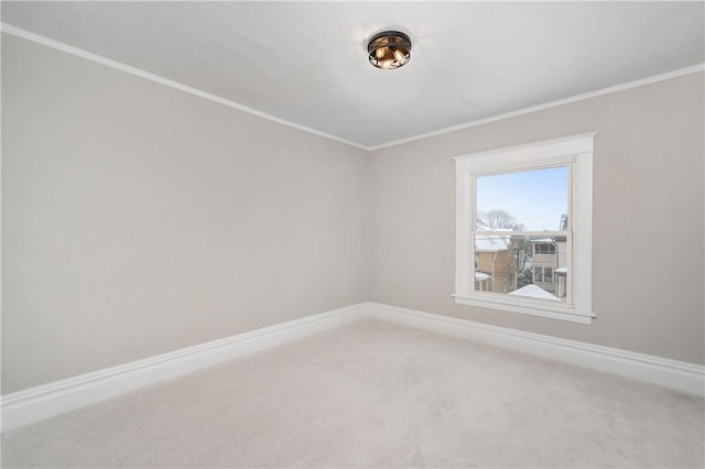 carpeted spare room with crown molding