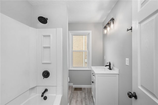 full bathroom featuring vanity, wood-type flooring, plenty of natural light, and tub / shower combination