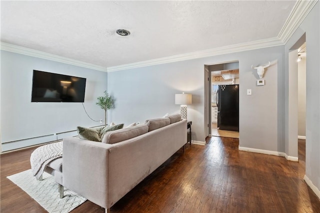 living room featuring ornamental molding, dark hardwood / wood-style flooring, and a baseboard heating unit