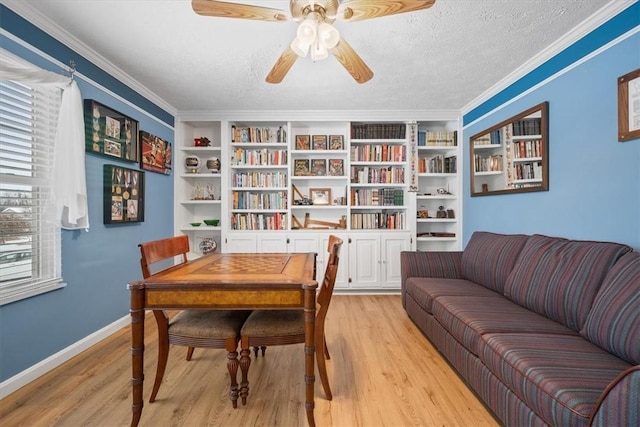 dining area with crown molding, built in features, a textured ceiling, and light hardwood / wood-style flooring