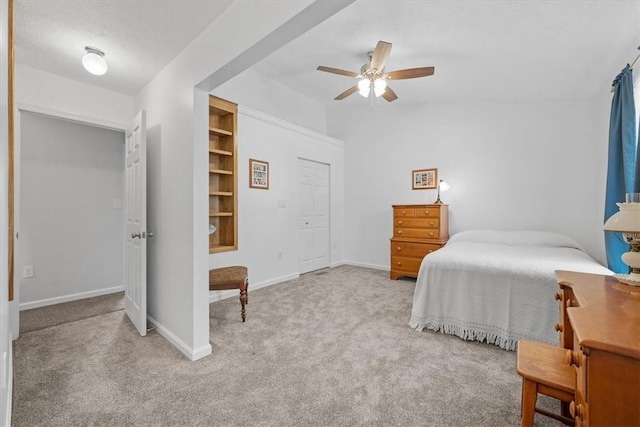 bedroom featuring ceiling fan, a closet, and light carpet