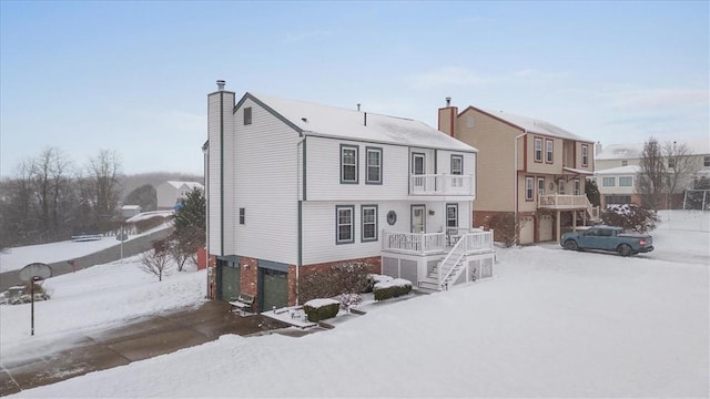 snow covered house with a garage