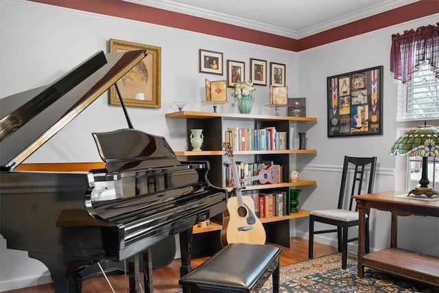 miscellaneous room with crown molding and hardwood / wood-style floors