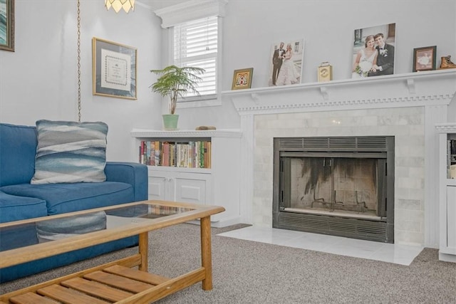 sitting room featuring a fireplace and light colored carpet