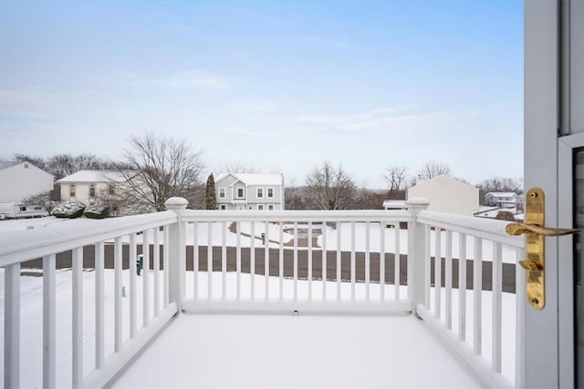 view of snow covered back of property