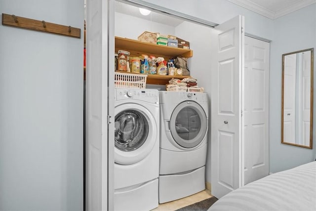 laundry room featuring washer and dryer and ornamental molding