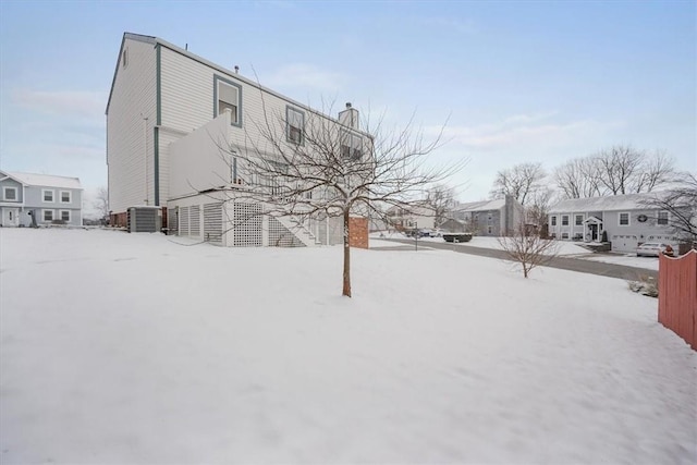 yard covered in snow featuring central air condition unit