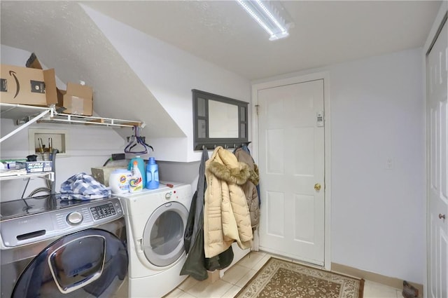 washroom with independent washer and dryer and light tile patterned floors