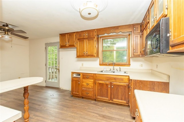 119 Deer Rd, Loyalhanna, PA 15681 - kitchen with a sink, black microwave, brown cabinetry, light countertops, and a ceiling fan