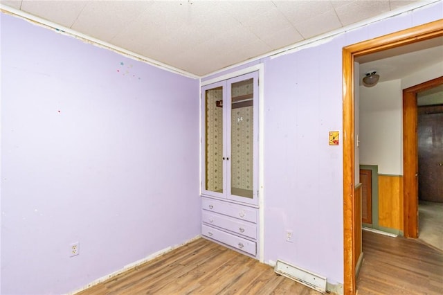 119 Deer Rd, Loyalhanna, PA 15681 - unfurnished room featuring light wood-type flooring, a baseboard radiator, and a wainscoted wall
