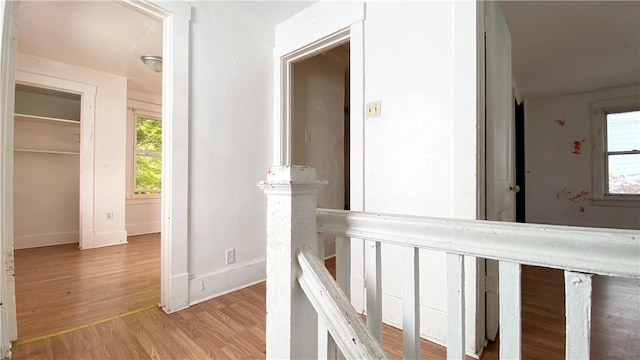 hallway with light hardwood / wood-style floors