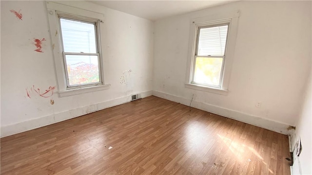 unfurnished room featuring hardwood / wood-style floors