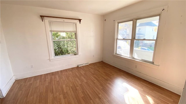 unfurnished room featuring hardwood / wood-style floors