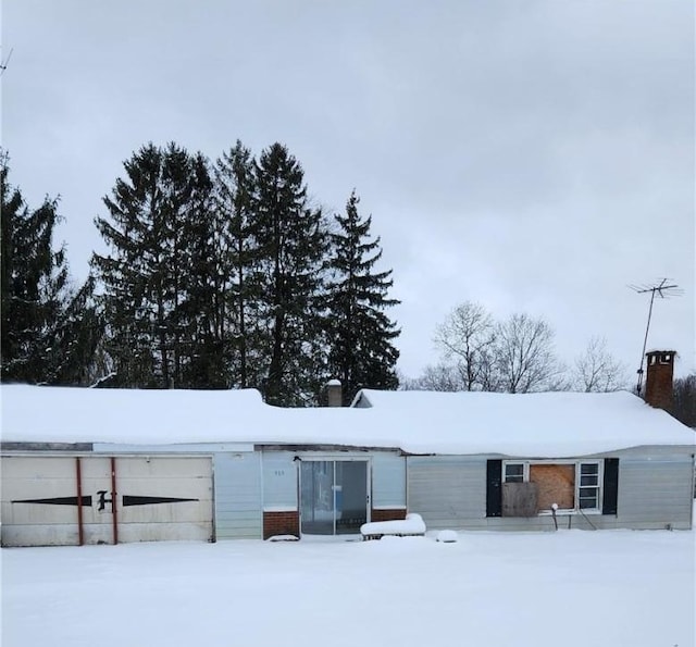 view of snow covered rear of property