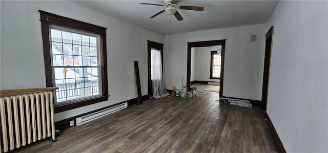 spare room with dark hardwood / wood-style flooring, ceiling fan, radiator heating unit, and a baseboard radiator