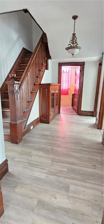 hallway with light hardwood / wood-style floors